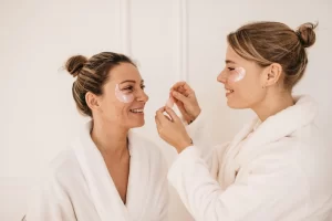 mother daughter with fair skin wear bathrobes fight bruises dark circles eyes with patches white background beauty procedure morning ritual concept 197531 31545