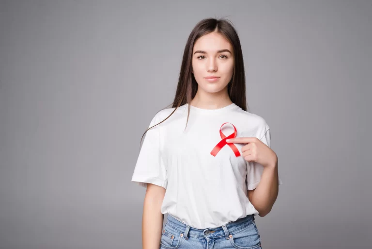 red ribbon breast cancer woman isolated gray wall 231208 11861